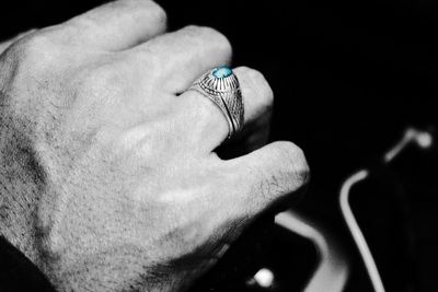 Close-up of woman hand on finger against black background