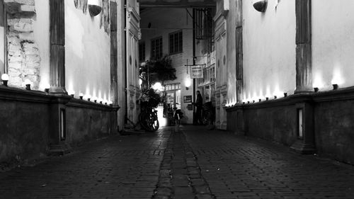 Street amidst buildings in city at night