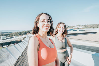 Portrait of young female friends standing outdoors