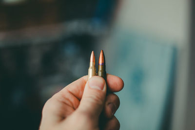Close-up of hand holding leaf