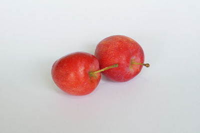 High angle view of cherries against white background