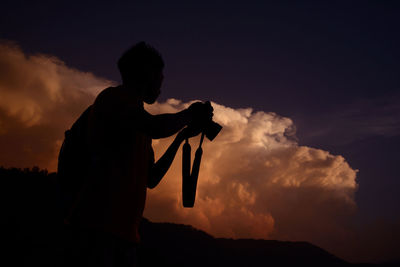 Silhouette of man against sky during sunset