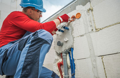 Rear view of man working at construction site