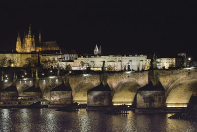 Illuminated buildings against sky at night