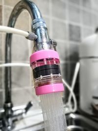 Close-up of faucet against black background