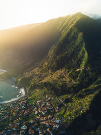 High angle view of city and mountains against sky