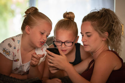 Close-up of mother and girl looking away