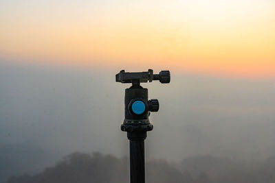 Low angle view of camera against sky during sunset