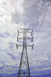 Low angle view of electricity pylon against sky