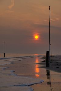 Scenic view of beach against sky during sunset