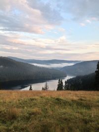 Scenic view of lake against cloudy sky