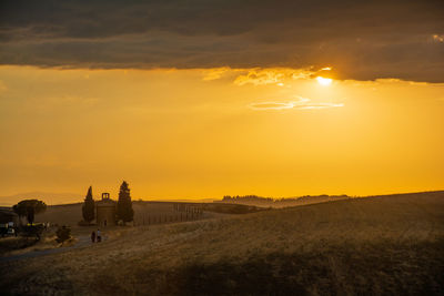 Scenic view of field against sky during sunset