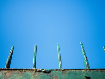 Low angle view of metallic structure against blue sky