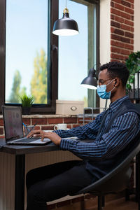 Businessman working in office during pandemic