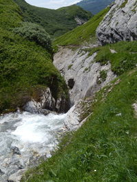 Scenic view of waterfall against sky