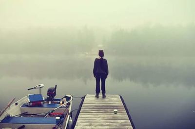 Woman standing in foggy weather