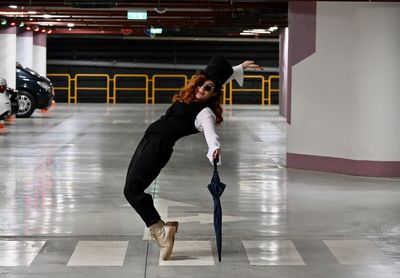 Full length portrait of woman standing on floor