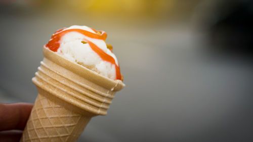 Close-up of hand holding ice cream cone