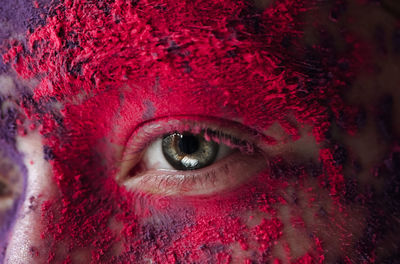 Close-up portrait of woman with multi colored powder paint