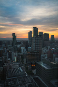 Aerial view of buildings against sky during sunset