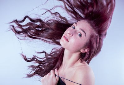 Portrait of beautiful woman against white background