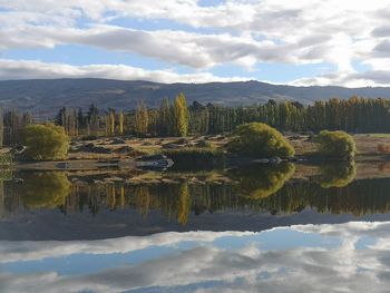 Scenic view of lake and mountains against sky