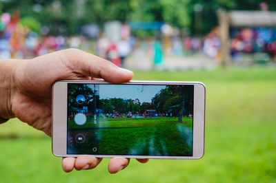 Cropped image of person photographing at nehru park