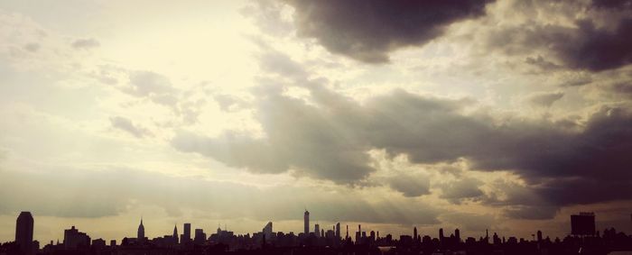 City skyline against cloudy sky