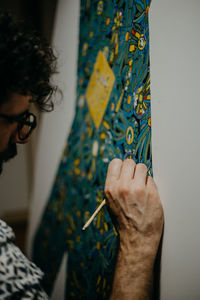 Midsection of woman holding painting