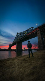 Full length of man standing on bridge against sky