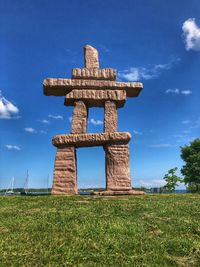 Built structure on field against sky