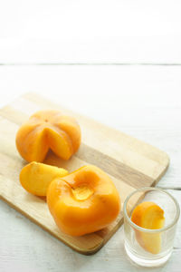 Close-up of persimmon on cutting board over table