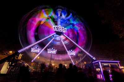 Low angle view of illuminated ferris wheel at night