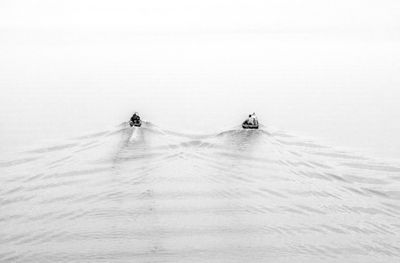 High angle view of people on motorboats sailing on river