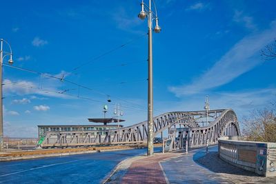 Bridge over sea against blue sky