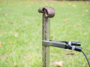 Close-up of rusty metal on field at park