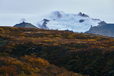 Scenic view of snowcapped mountains against sky