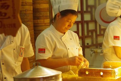 Chefs preparing food in commercial kitchen