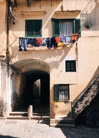 Clothes drying on alley amidst buildings in city