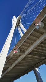 Low angle view of bridge against clear blue sky