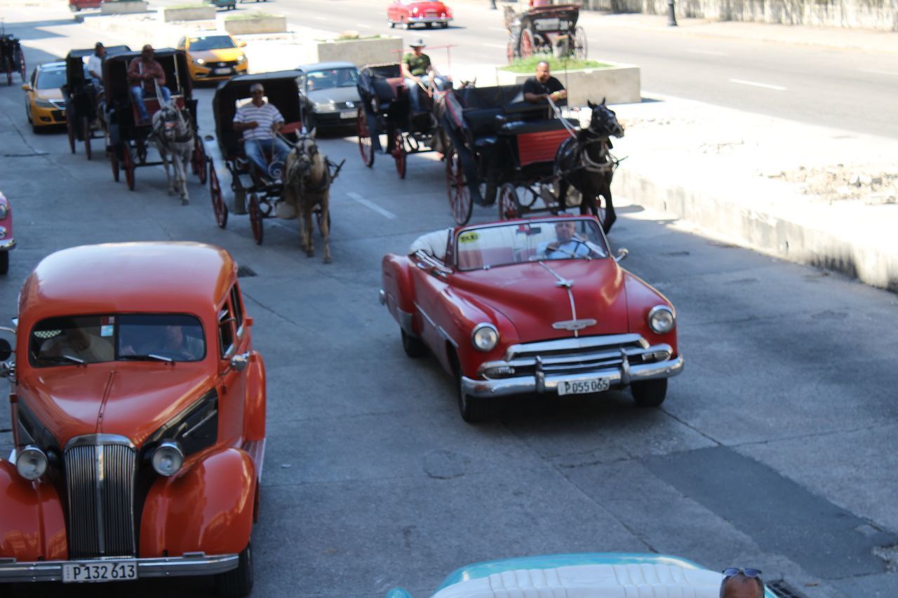 PEOPLE ON ROAD WITH CITY IN BACKGROUND