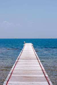 Pier over sea against clear sky