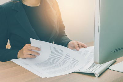 Midsection of woman working on table