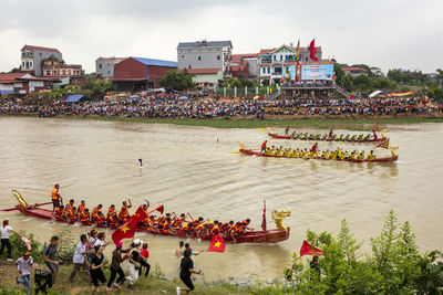 High angle view of people by boats in river