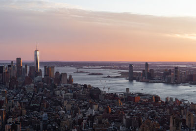 Aerial view of cityscape against sky during sunset