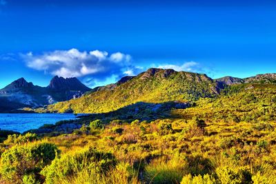 Scenic view of mountains against blue sky