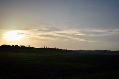 Scenic view of field against sky during sunset