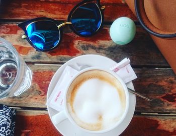 Directly above shot of cappuccino served on table