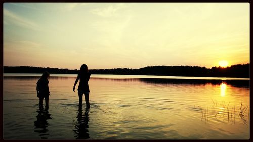 Scenic view of lake at sunset