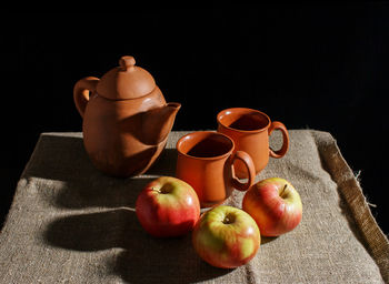 Close-up of apples on table against black background